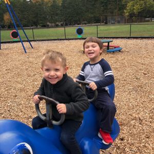 boys on riding toy on playground