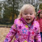 girl with big smile on playground