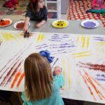 children painting with toy cars