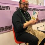 Man reading story to preschoolers