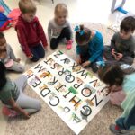 kids completing a floor puzzle together